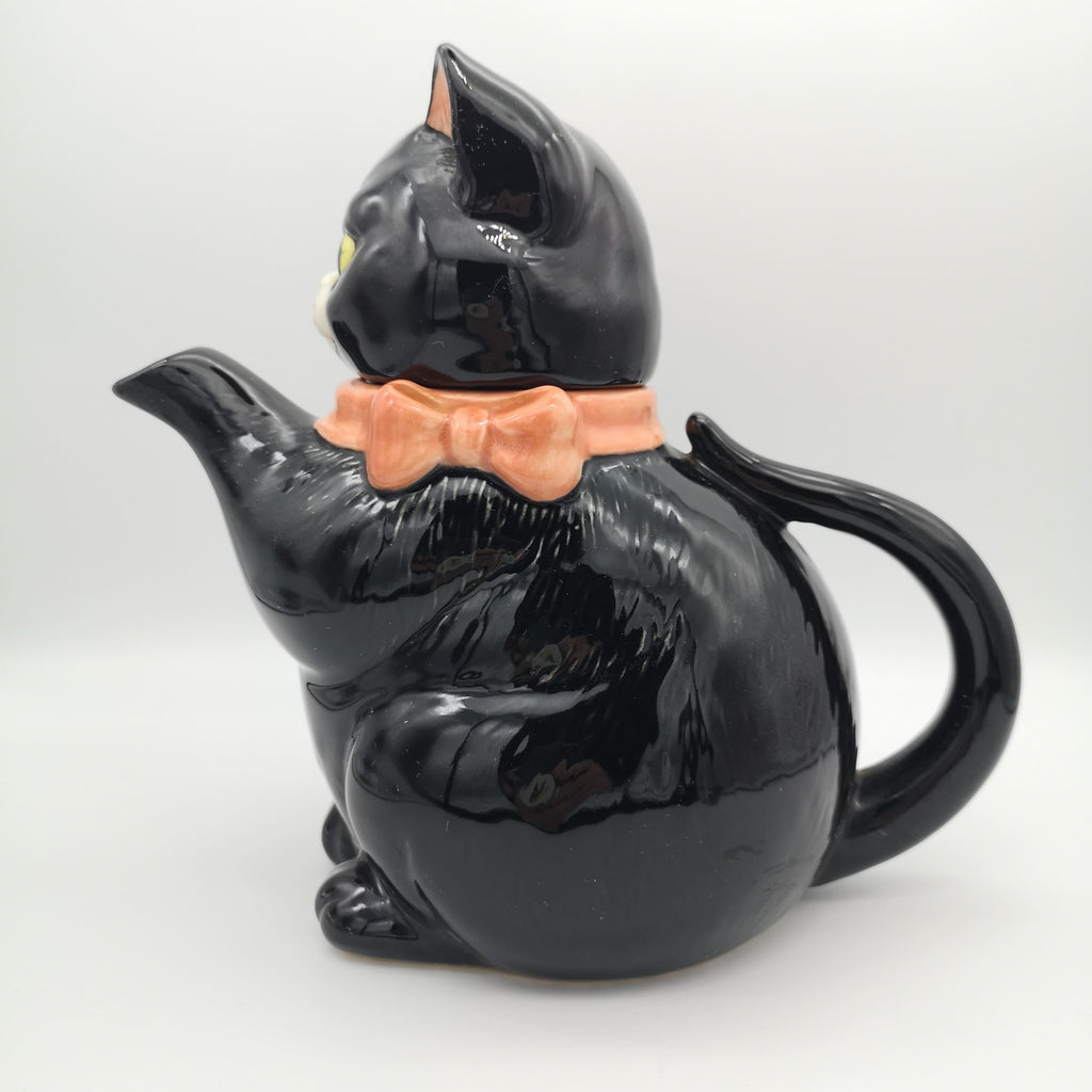 Teekanne in Form einer schwarzen Katze mit rosa Schleife
