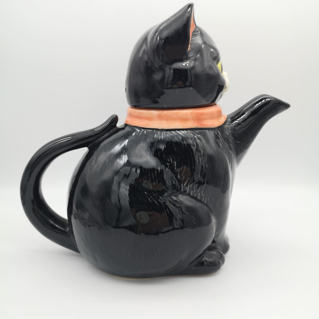 Teekanne in Form einer schwarzen Katze mit rosa Schleife