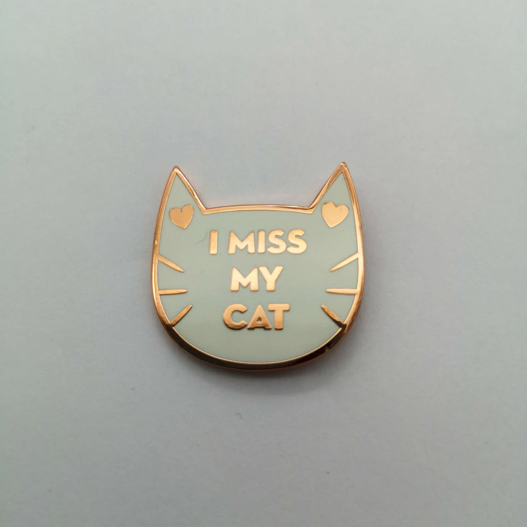 Weißer Pin mit Goldrand in Katzenform und mit der Aufschrift "I miss my cat"